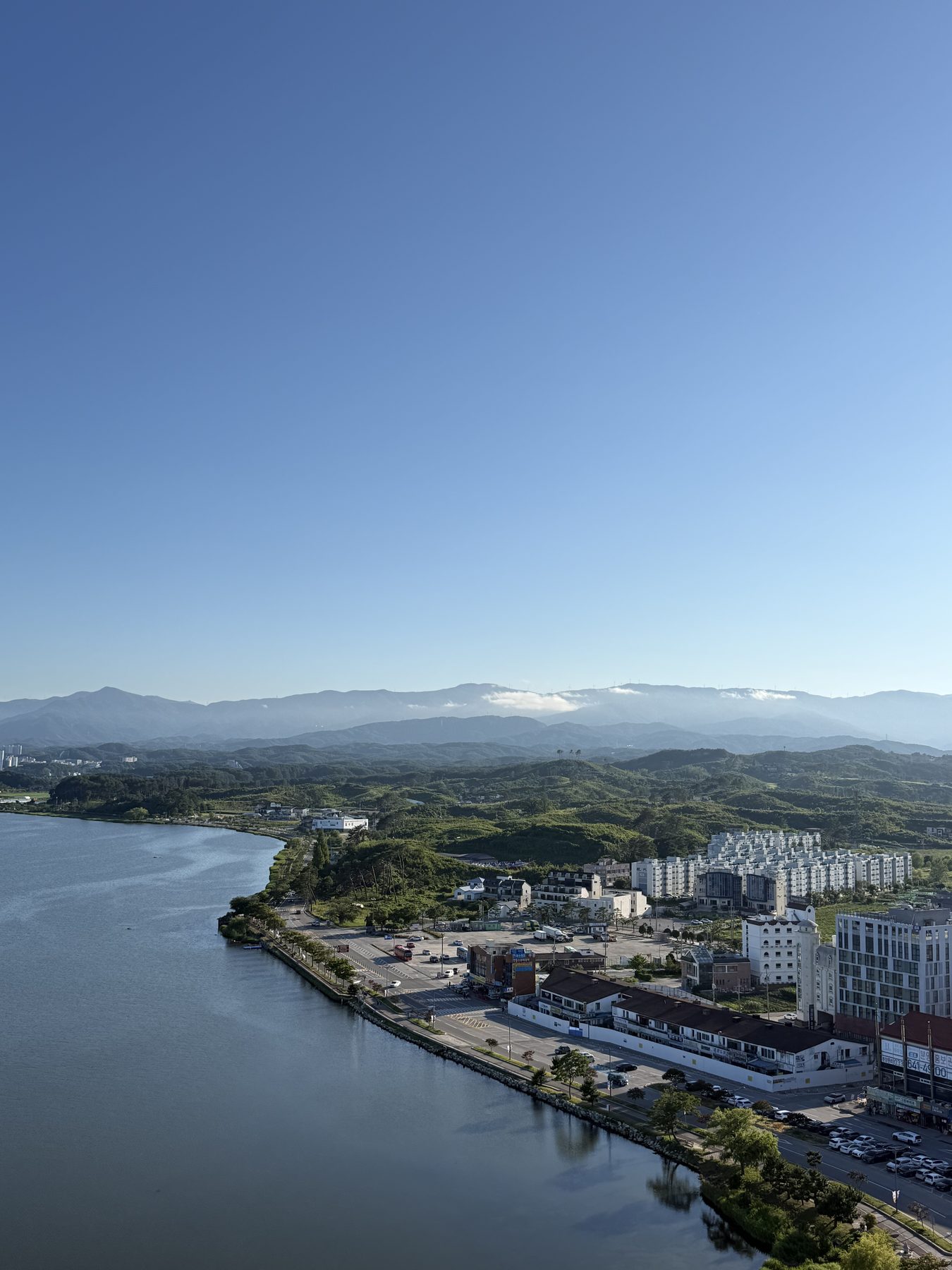 Lake, city and mountains under blue sky in Gangneung