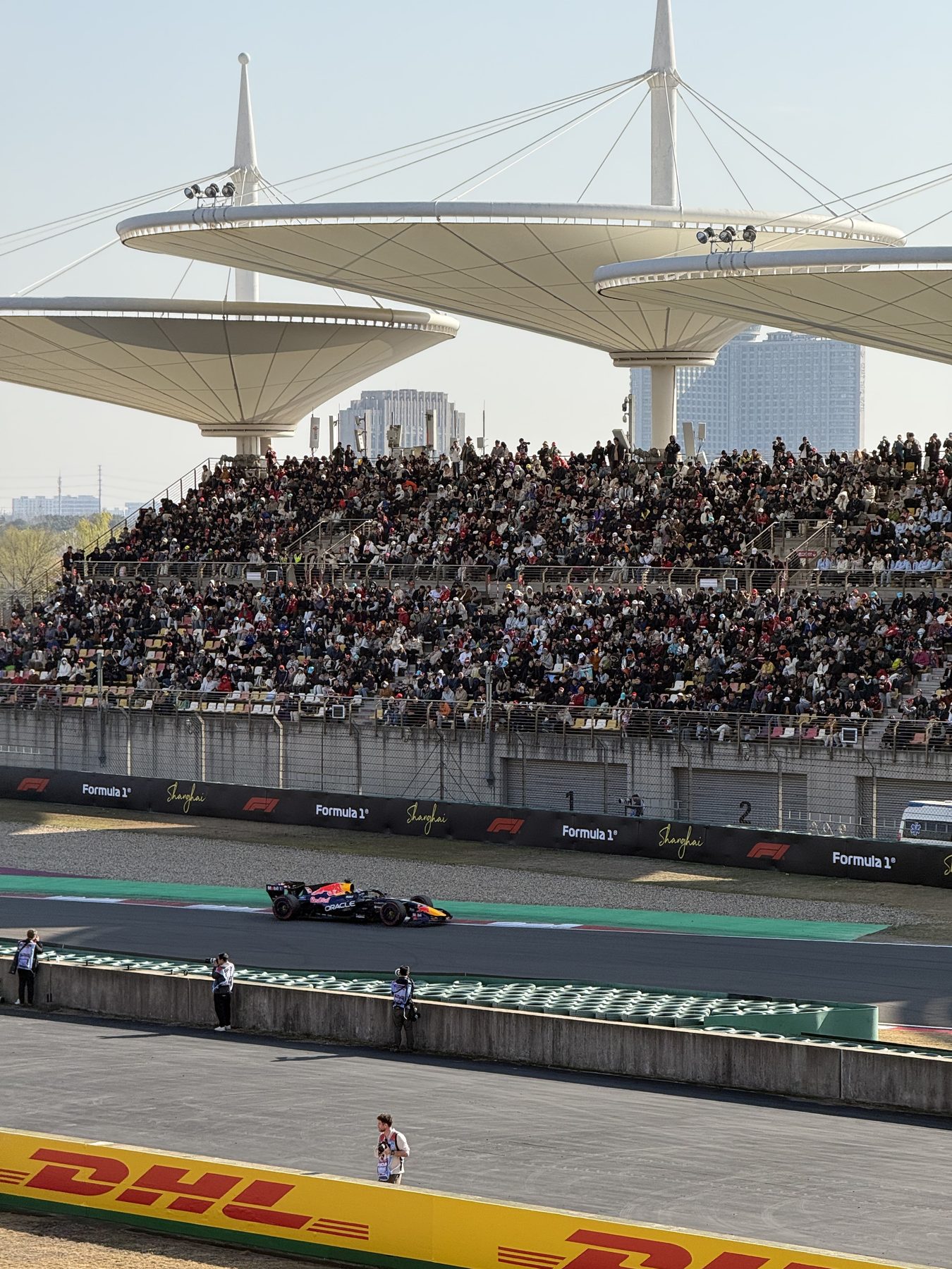 A Formula One car passing a packed crowd at the 2026 Shanghai Grand Prix