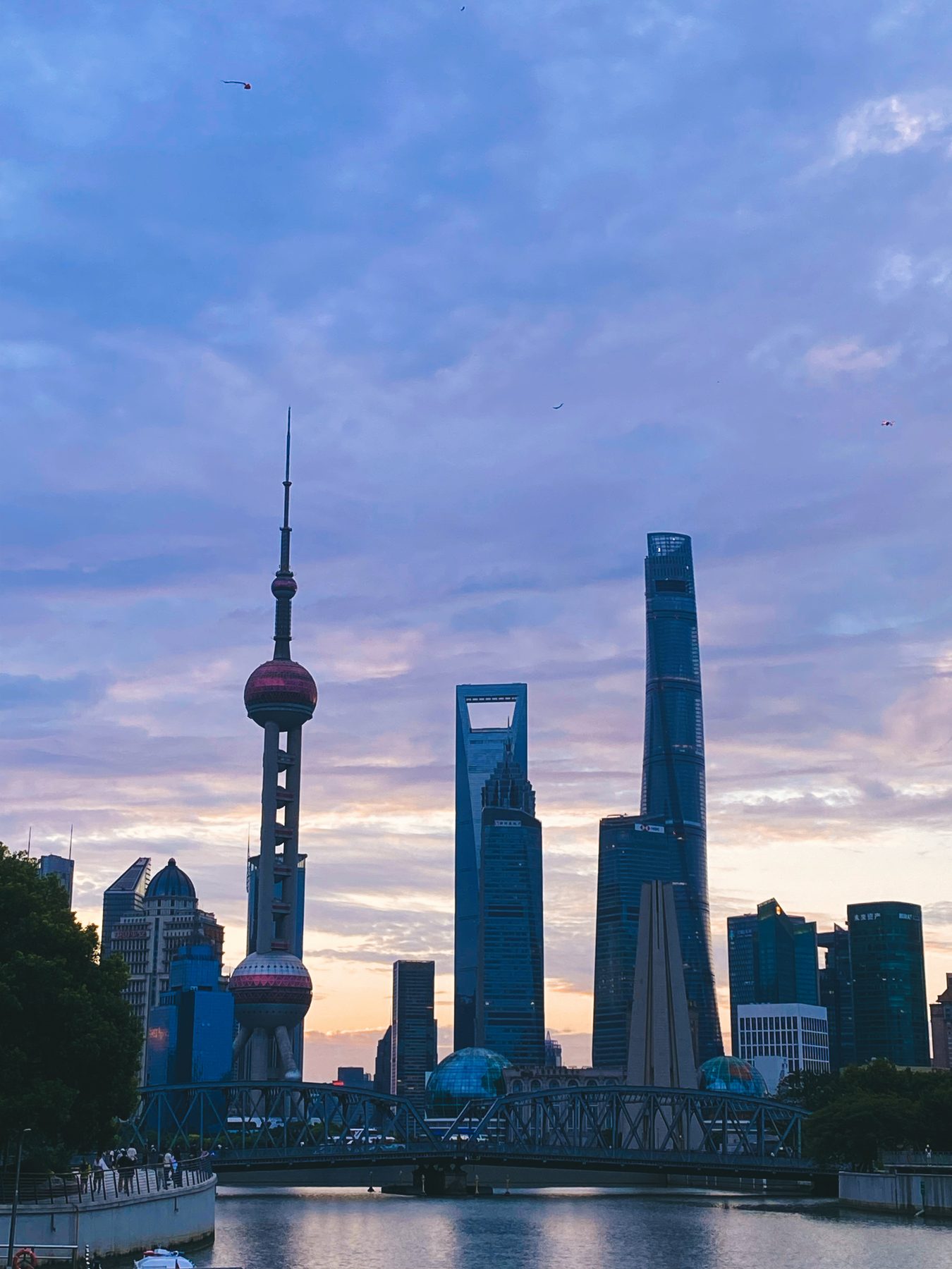 Shanghai’s Lujiazui skyline at sunrise across the river and bridge