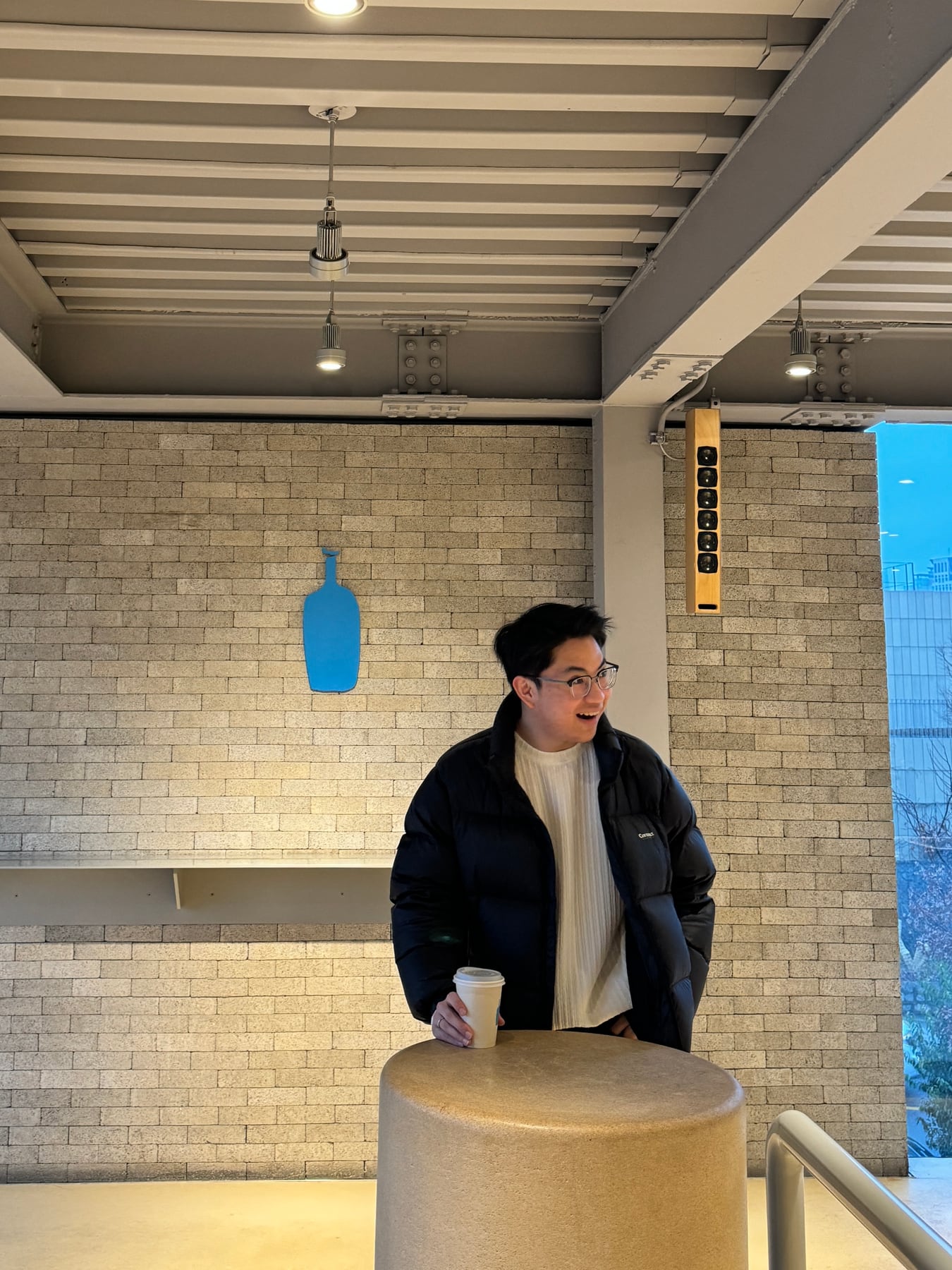 Aspen holding a coffee